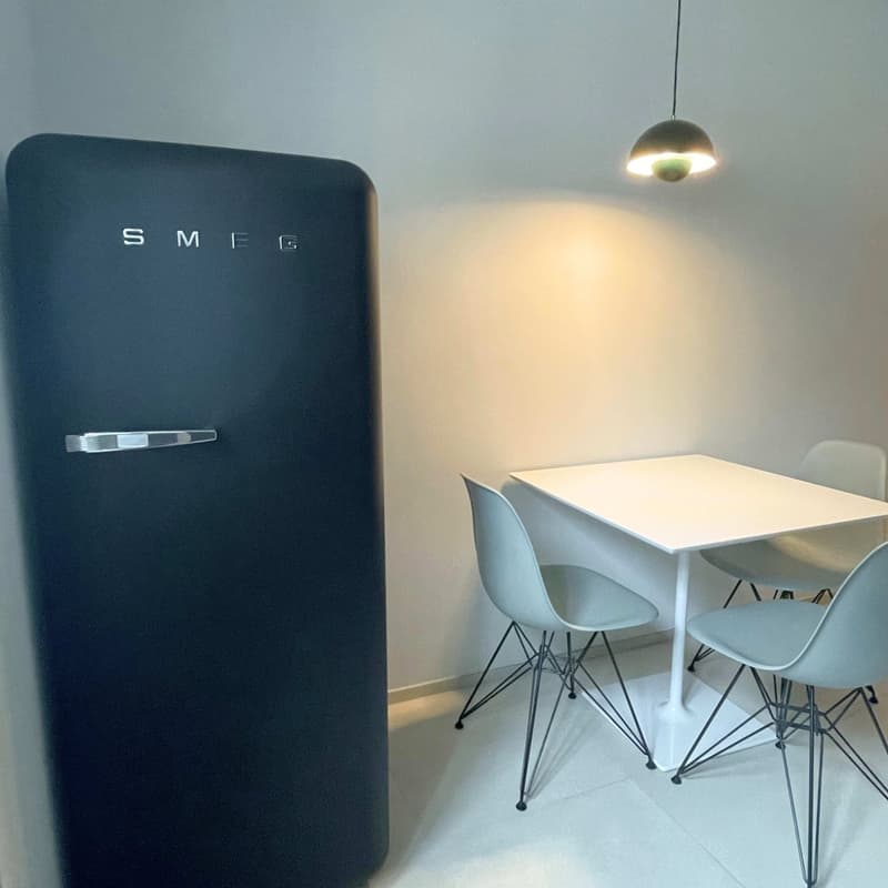 White countertop, modern table and chairs, vintage fridge, hanging lamp