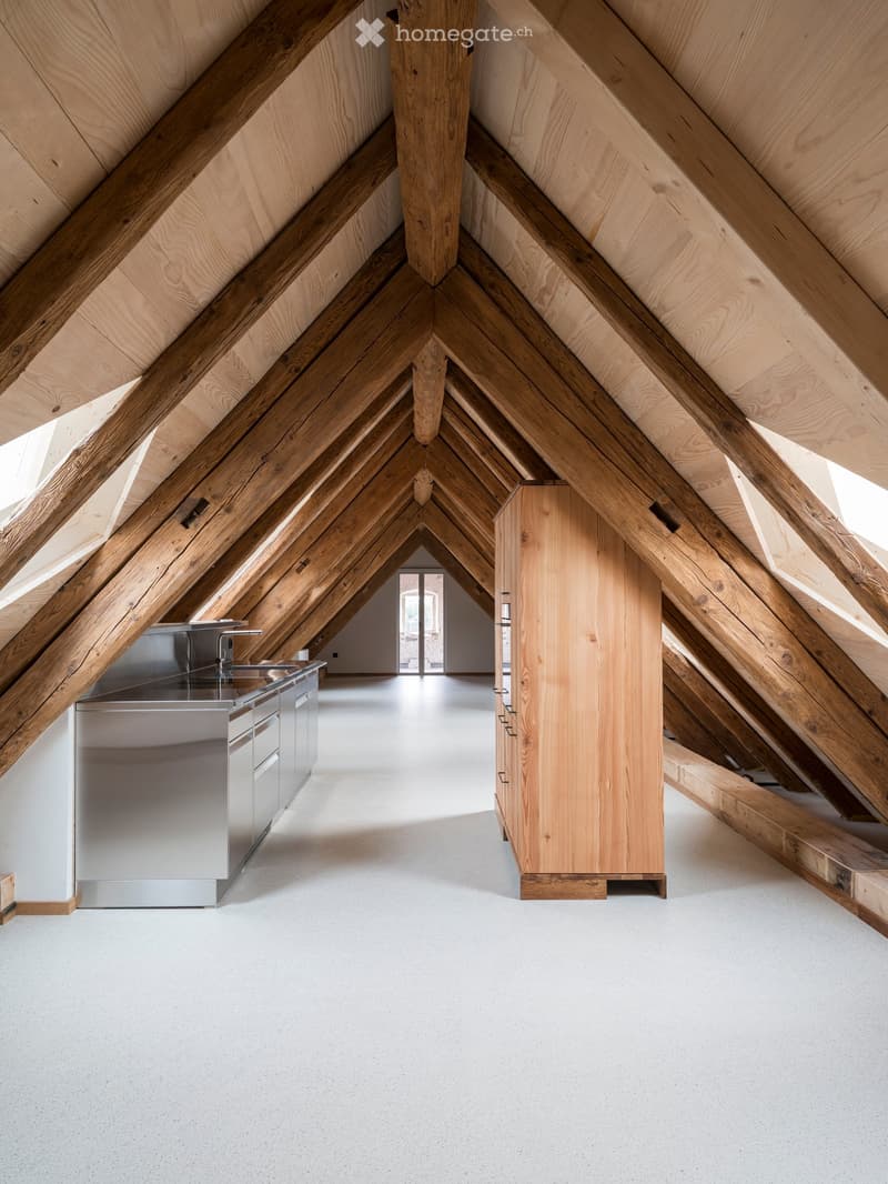 Wooden ceiling beams, wooden cabinet, stainless steel counter, wooden flooring