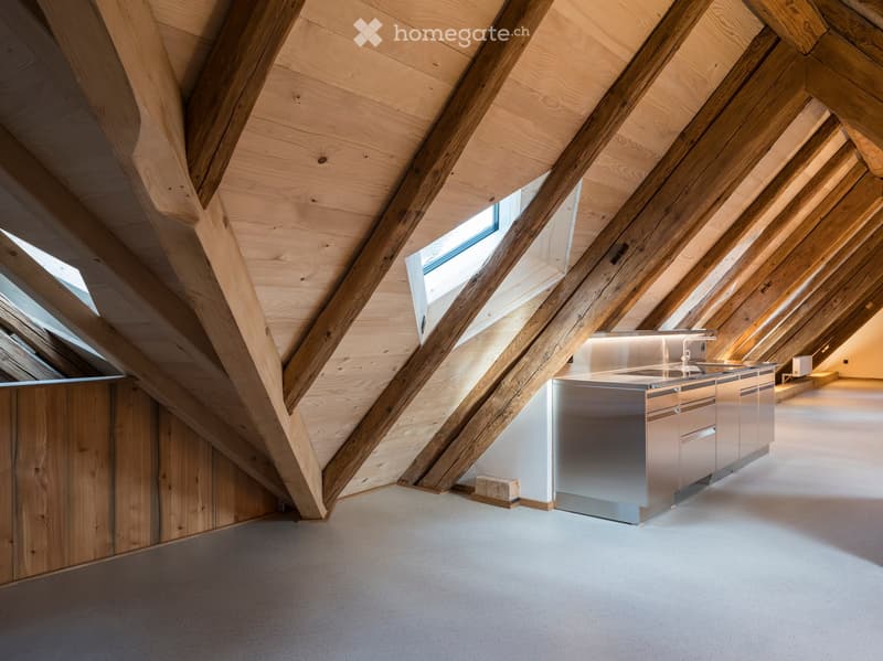 attic kitchen, wooden beams, stainless steel counter, skylight
