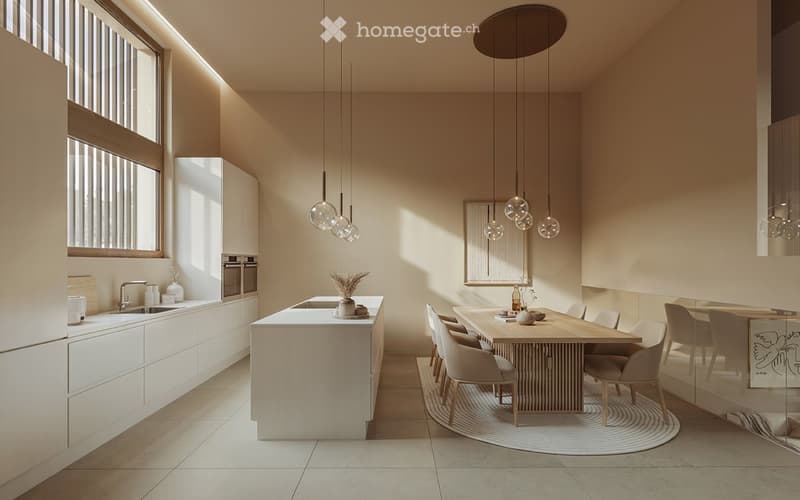 Spacious open-concept kitchen and dining area with modern, minimalist design. The kitchen features a large white island with built-in appliances, including a dishwasher. The dining table is made of wood and surrounded by comfortable chairs. Pendant lighti