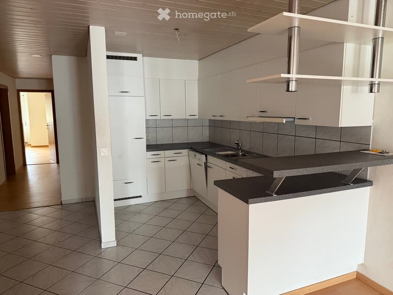 Modern kitchen, white cabinets, tiled floor, granite countertops, stainless steel appliances