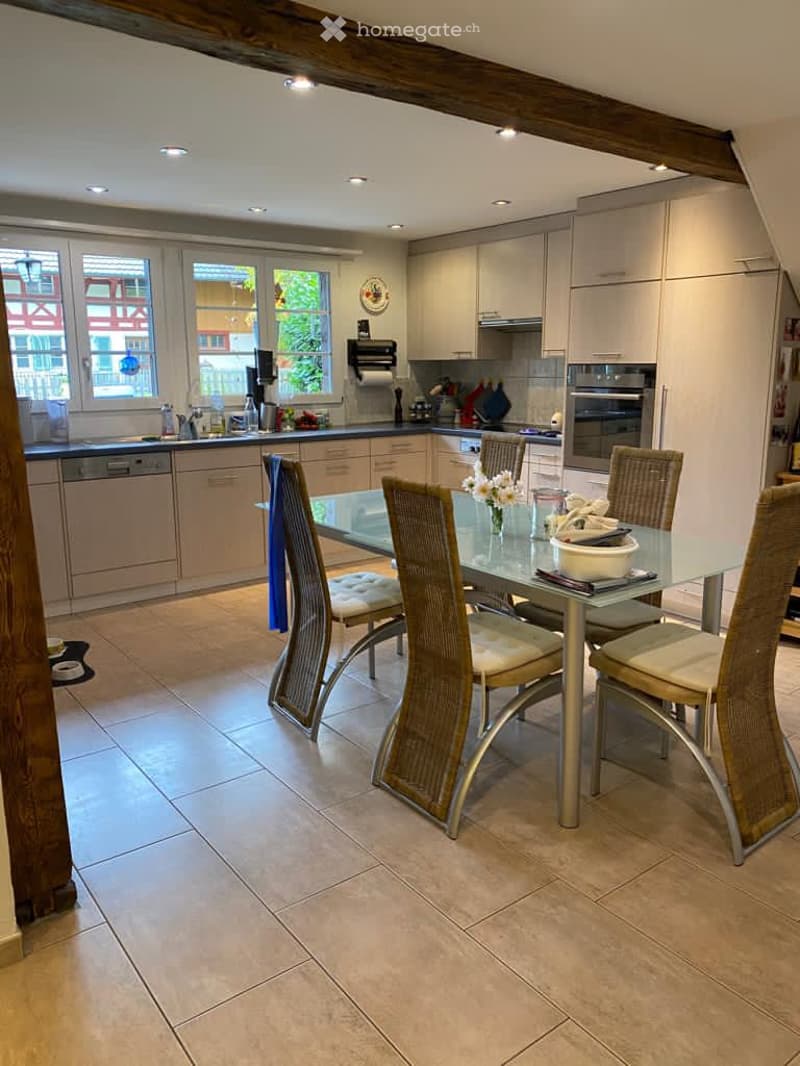 modern kitchen, tiled floor, breakfast table, dishwasher, white cabinets, oven, windows, natural light