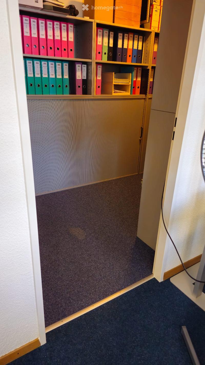 open office room with cabinets and shelves