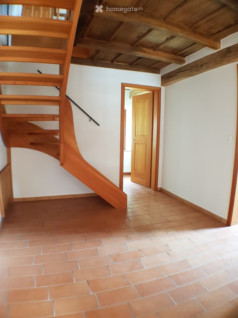 wooden staircase, wooden beams, wooden floor, wooden door, white walls