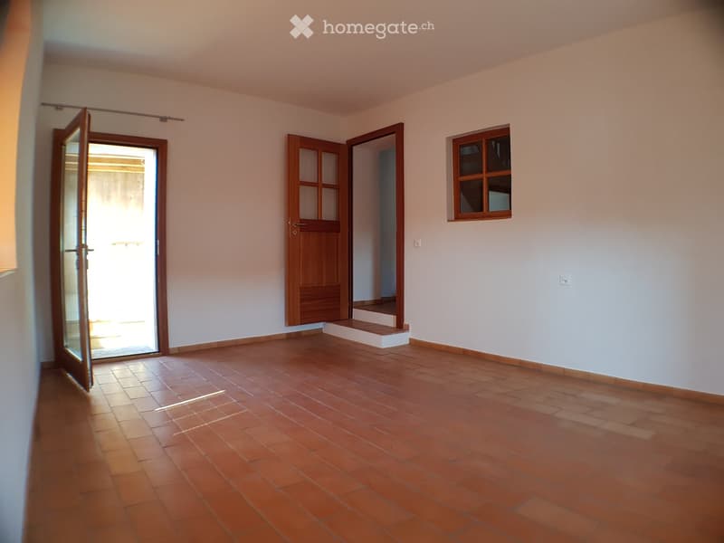 Empty room, wooden tiles floor, white walls, wooden door, windows, open door, staircase