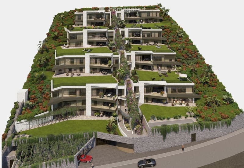 Aerial view of the building complex, rooftop gardens, terraces, and open green spaces