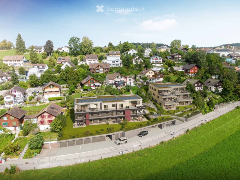 modern apartments, garages, parking spots, solar panels, terraced roofs, elevated on a hillside