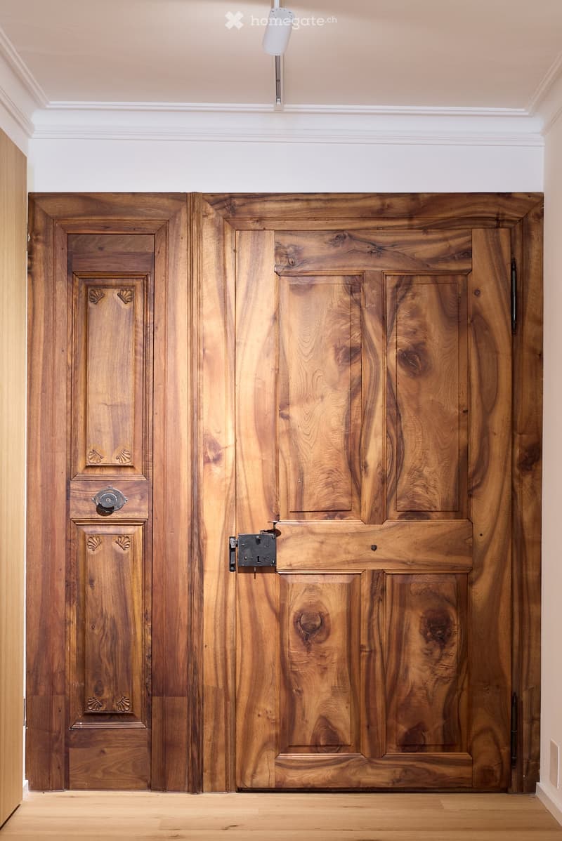 Double wooden door, wooden frame, metal hinges, brass handles