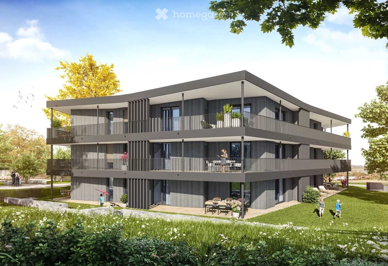 Modern building with balconies on all floors, located in a park setting.
