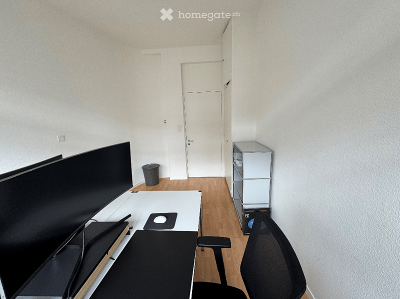 modern office desk with two screens, office chair, trash can, metal cabinet
