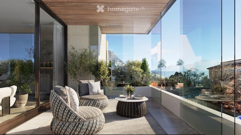 A balcony with two round chairs, round table, plants, and large glass walls.