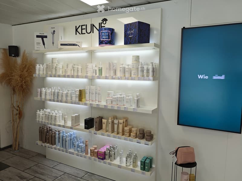 a display of hair care products with boxes on the top shelf and bottles on the lower shelves