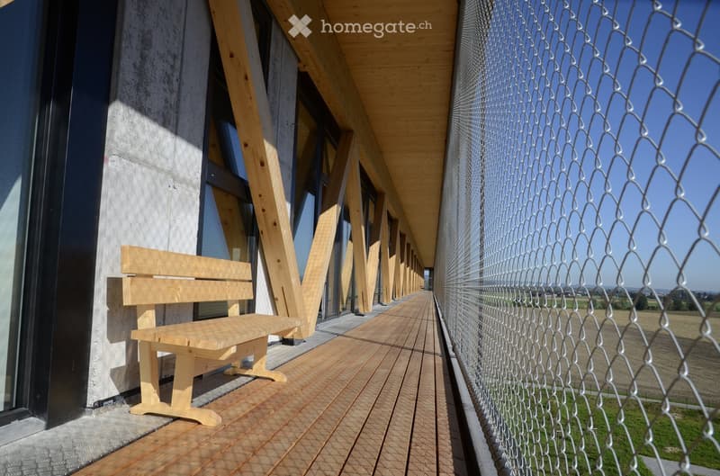 balcony with a wooden bench and wooden decking with wooden railings