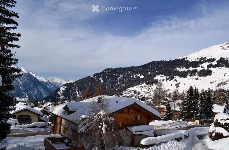 Chalet in the snowy mountains, wooden exterior, covered in snow, snow on the roof, pine trees, mountains in the background