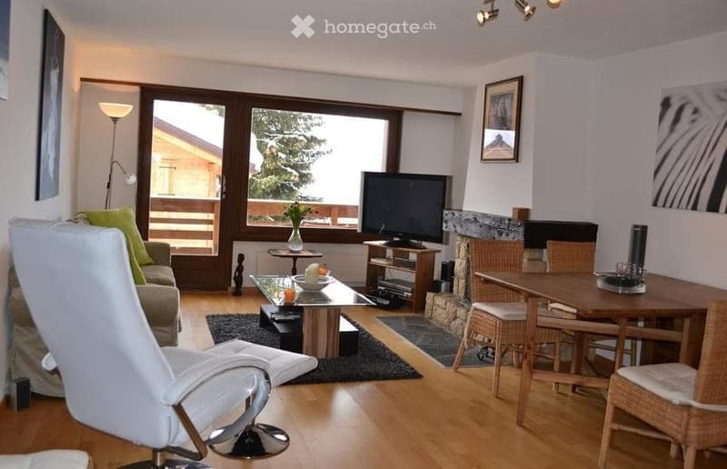 white furniture, hardwood floor, fireplace, television, large windows, table, chairs