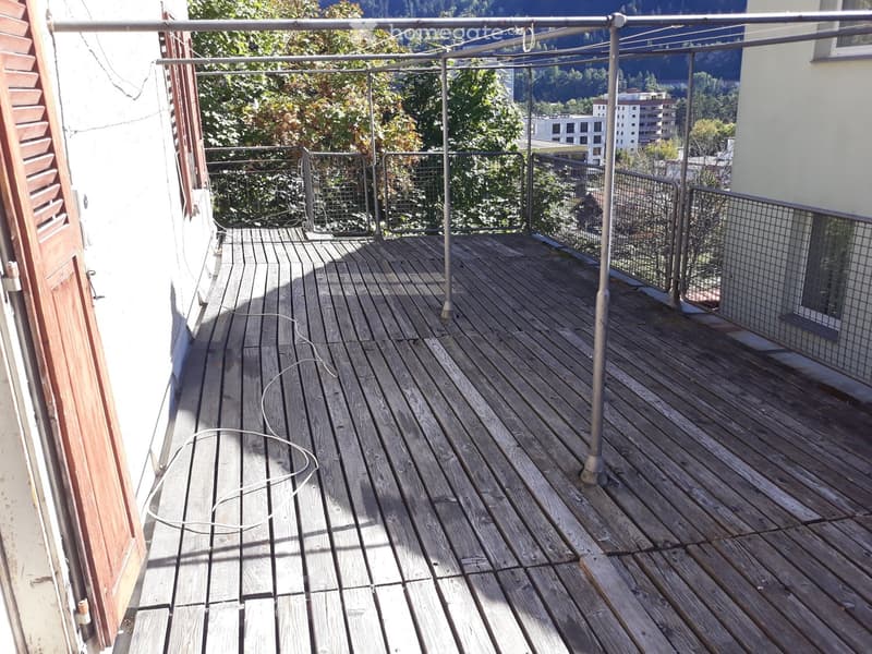 wooden deck, metal poles, metal fencing, building