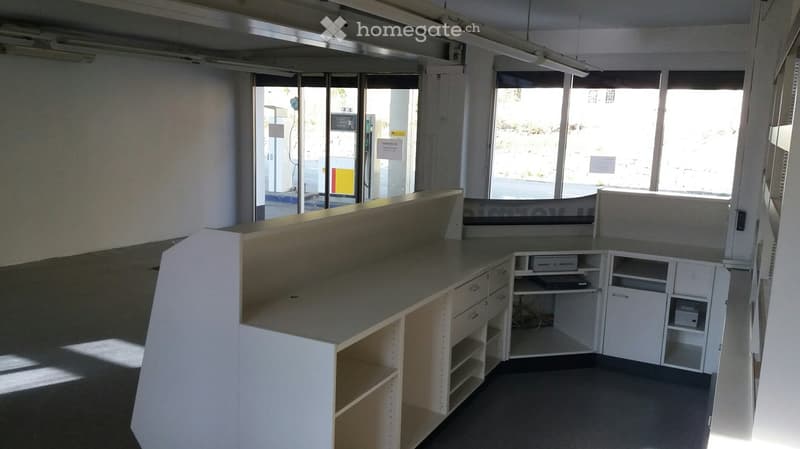 Counter and shelves in front of glass doors, cabinets and shelves on the sides