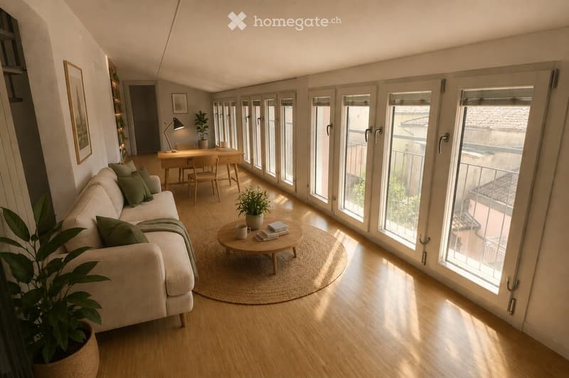 Bright living room with large windows and sliding doors leading to a balcony. Features a light-colored sofa with green cushions, a round coffee table with a plant, a small desk with a lamp, and a potted plant near the window.