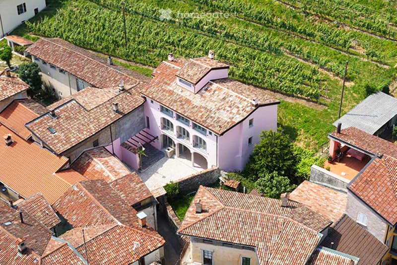 Detached house with multiple terraces, surrounded by farmland and other houses