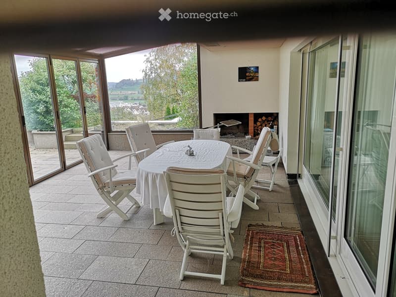 Table with 6 chairs, fireplace, glass doors, wooden rug, tile floor, panoramic windows, balcony