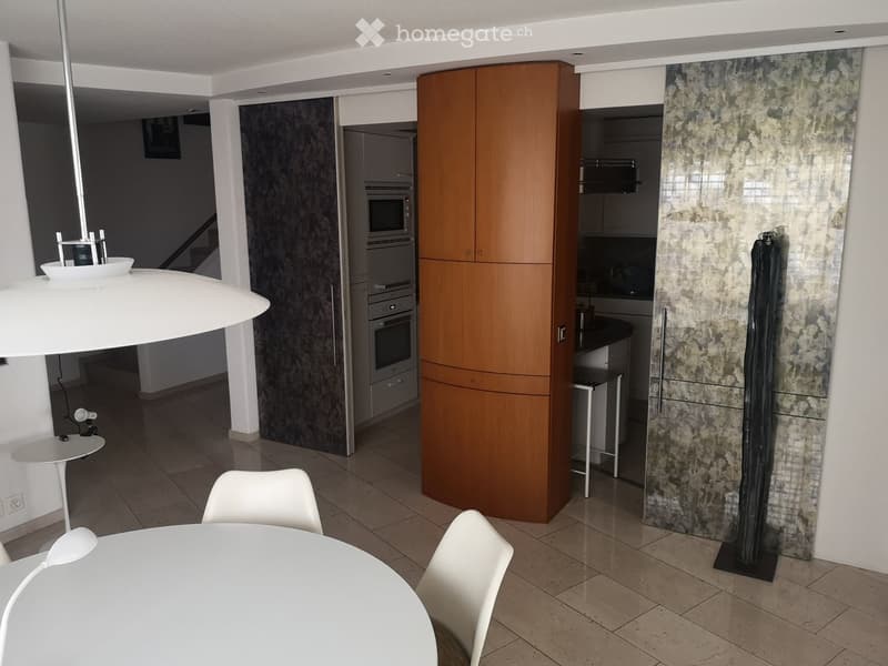 modern kitchen with large wooden cabinet, white countertops, white tiles, modern lighting