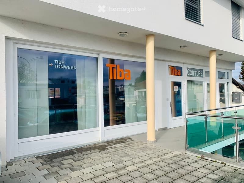 White building with glass doors and windows, Tiba written on the glass in orange
