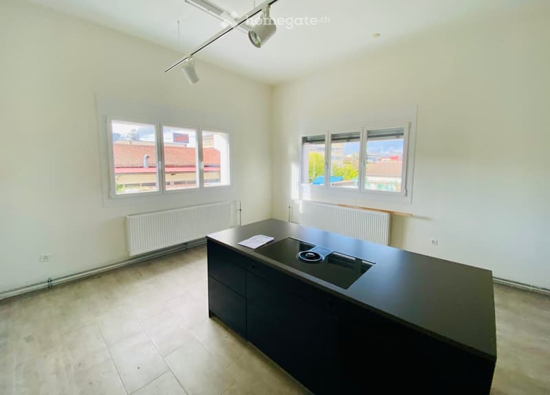 empty room, large kitchen island, two windows, two radiators