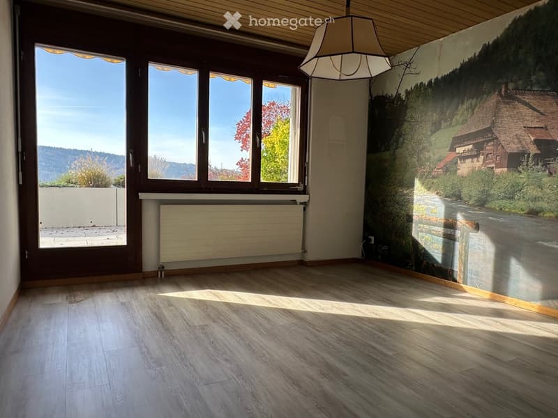 large windows, white radiator, wooden floor, scenic wallpaper, wooden door, pendant light