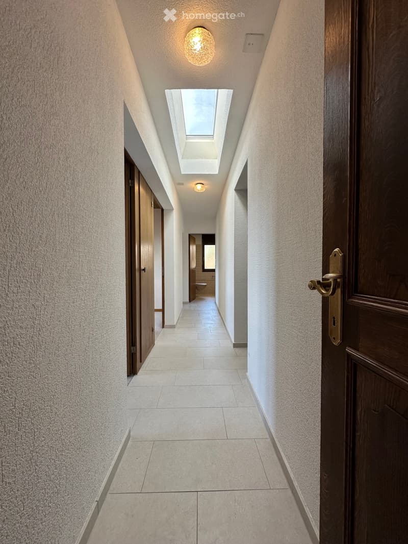 tiled floor, two ceiling lights, wooden doors