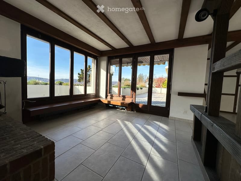 open room with large windows, tile flooring, built-in bench, fireplace
