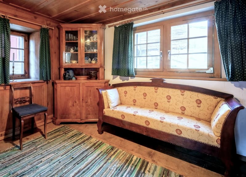 large wooden sofa, wooden chair, wooden cabinet, floor to ceiling windows, wooden floor