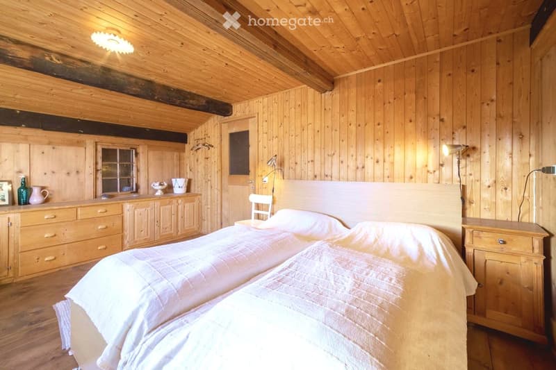 wooden room, two twin beds, wooden bed heads, wooden furniture, wooden floor