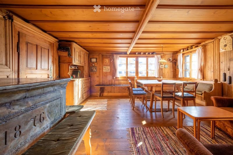 wooden interior, dining table and chairs, wooden benches, carpets, cupboards, windows with white curtains