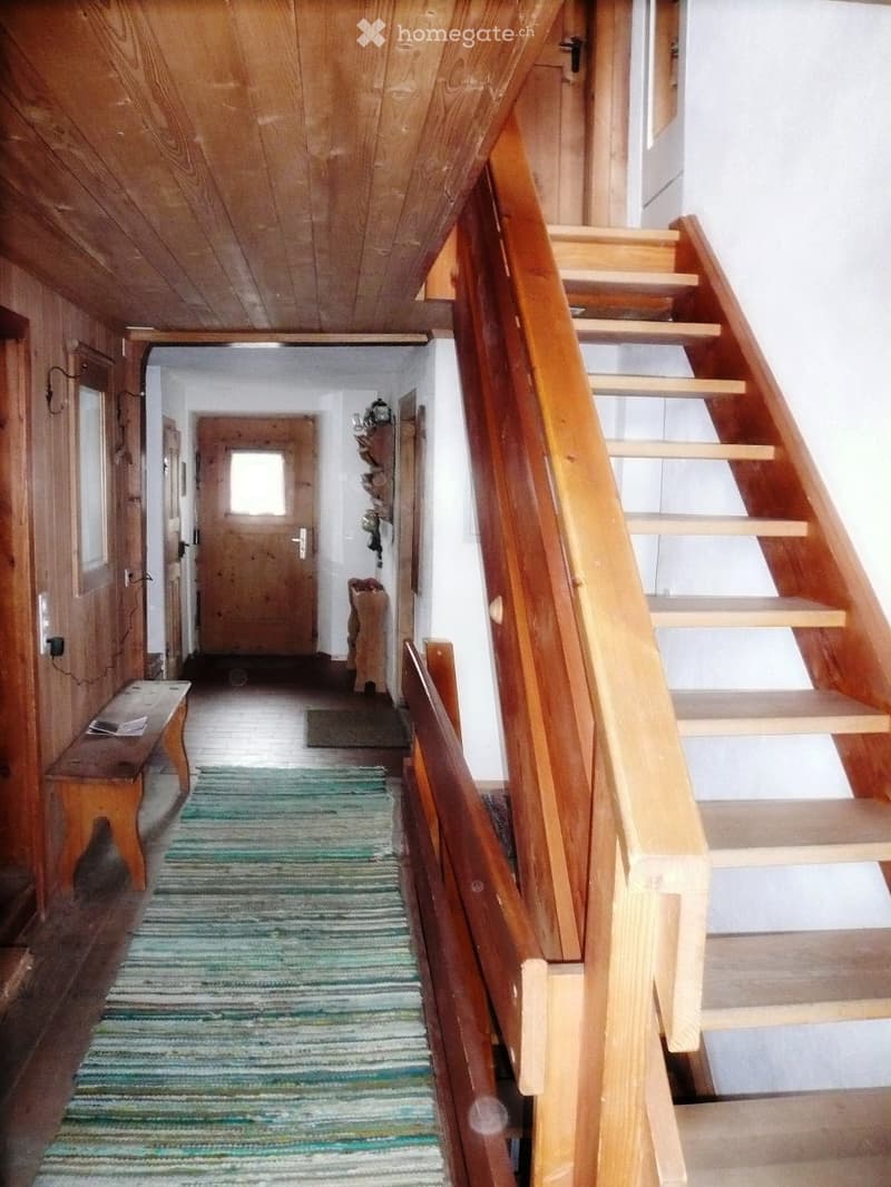 wooden ceiling, carpeted floor, wooden bench, carpeted steps, wooden staircase, wooden door