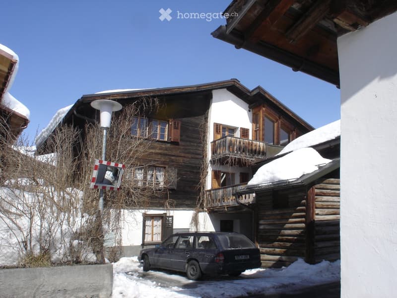 2 story house, wooden exterior, covered garage, snow on roof