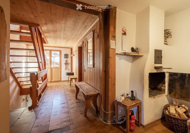 wooden flooring, wood walls, fireplace, stairs, bench, fire extinguisher