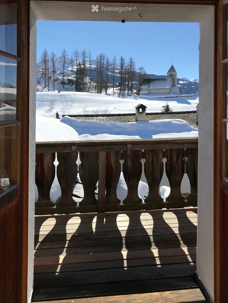 wooden balcony, snowy landscape, church, mountains