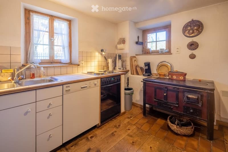 white cabinets, stainless steel sink, oven, dishwasher, wooden floor