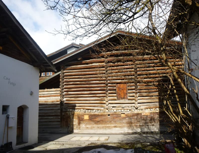 Traditional log cabin house, brick chimney, wooden window, wooden door, rustic appearance, stones on the base, stone pathway