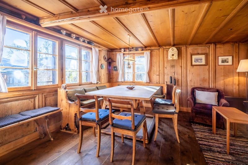 dining table with chairs, bench, fireplace, lamps, window, painting