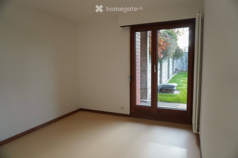 empty room, glass door, white walls, white floor, power outlet on the wall