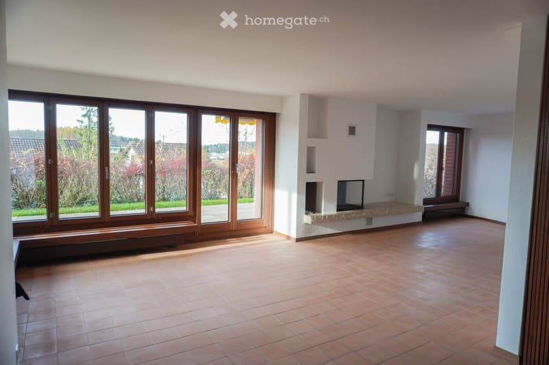 Large windows, fireplace, tiled floor, no furniture