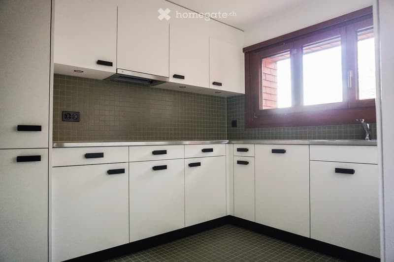 modern white kitchen, kitchen sink, window, tiled countertop, kitchen cabinets, power outlets, tiled floor