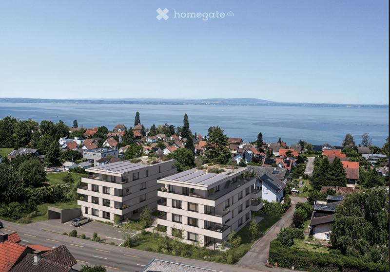 Two residential buildings, modern architecture, solar panels on the roof, coastal city, greenery around the buildings
