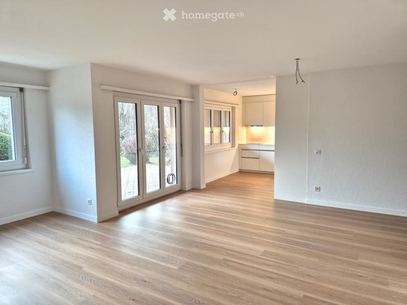 wooden floor, sliding glass doors, large windows, white walls