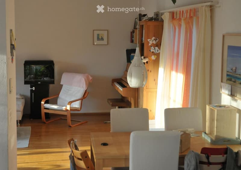living room, wooden floor, piano, white chairs, aquarium, wooden cabinet, picture frames, curtain