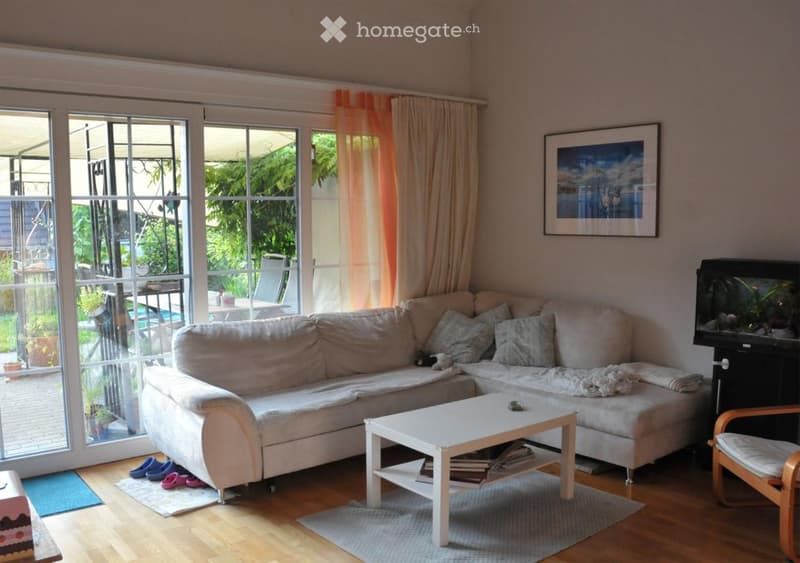 L-shaped sofa, coffee table, armchair, aquarium, picture frame, sliding glass door, rug, carpet