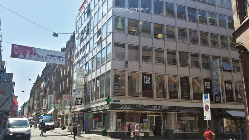 Multistory building with storefronts and signs at street level