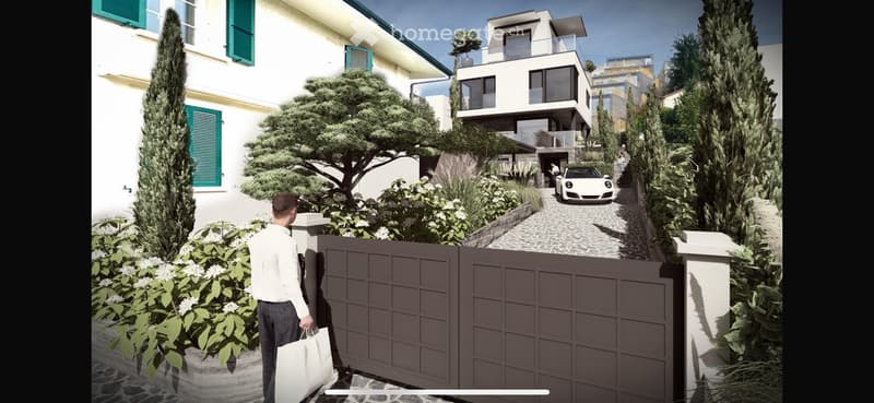A modern two-story house with a garage and parking area, surrounded by greenery and a well-maintained garden.