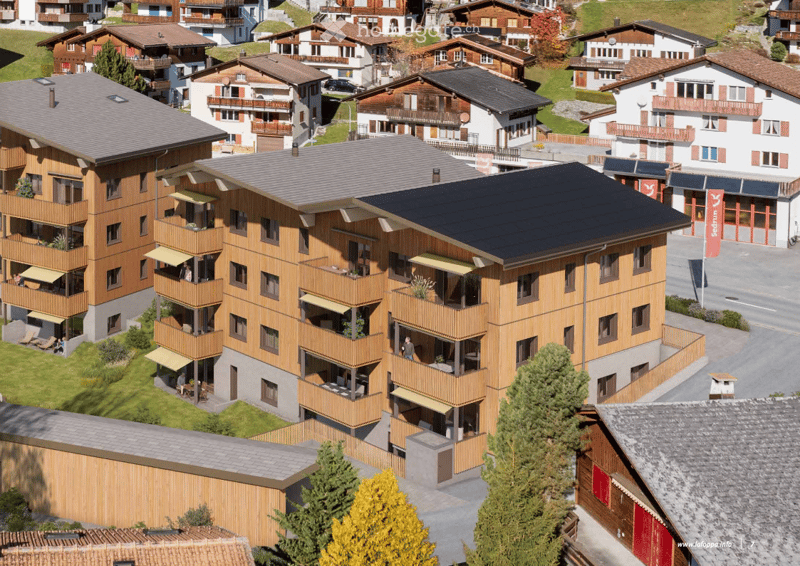 Apartment complex, 4 floors, wooden exterior, solar panels, balconies, green lawn